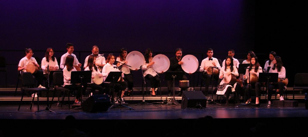 A group of student musicians called the Music of Persia ensemble performs on stage