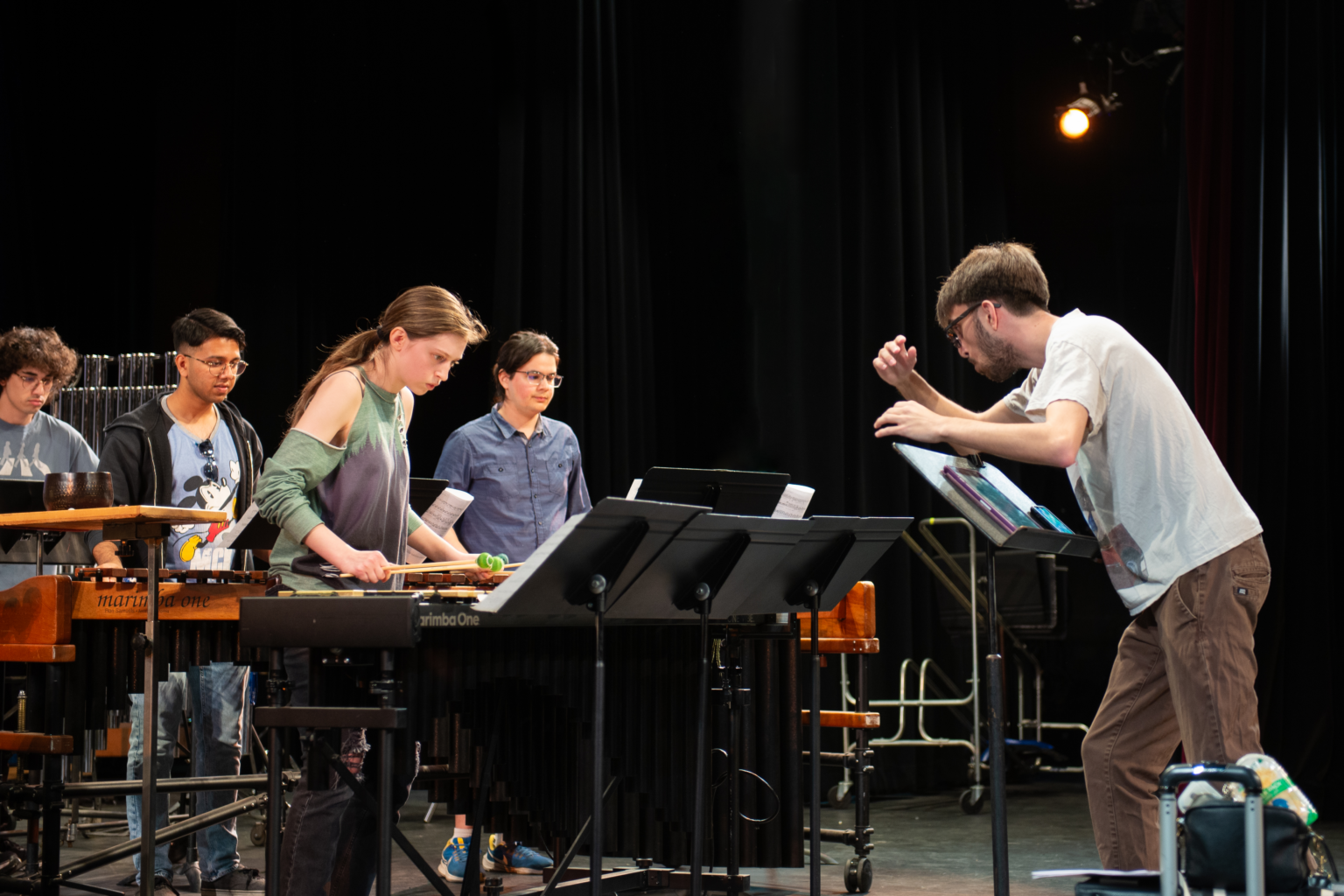 percussion ensemble and conductor on stage
