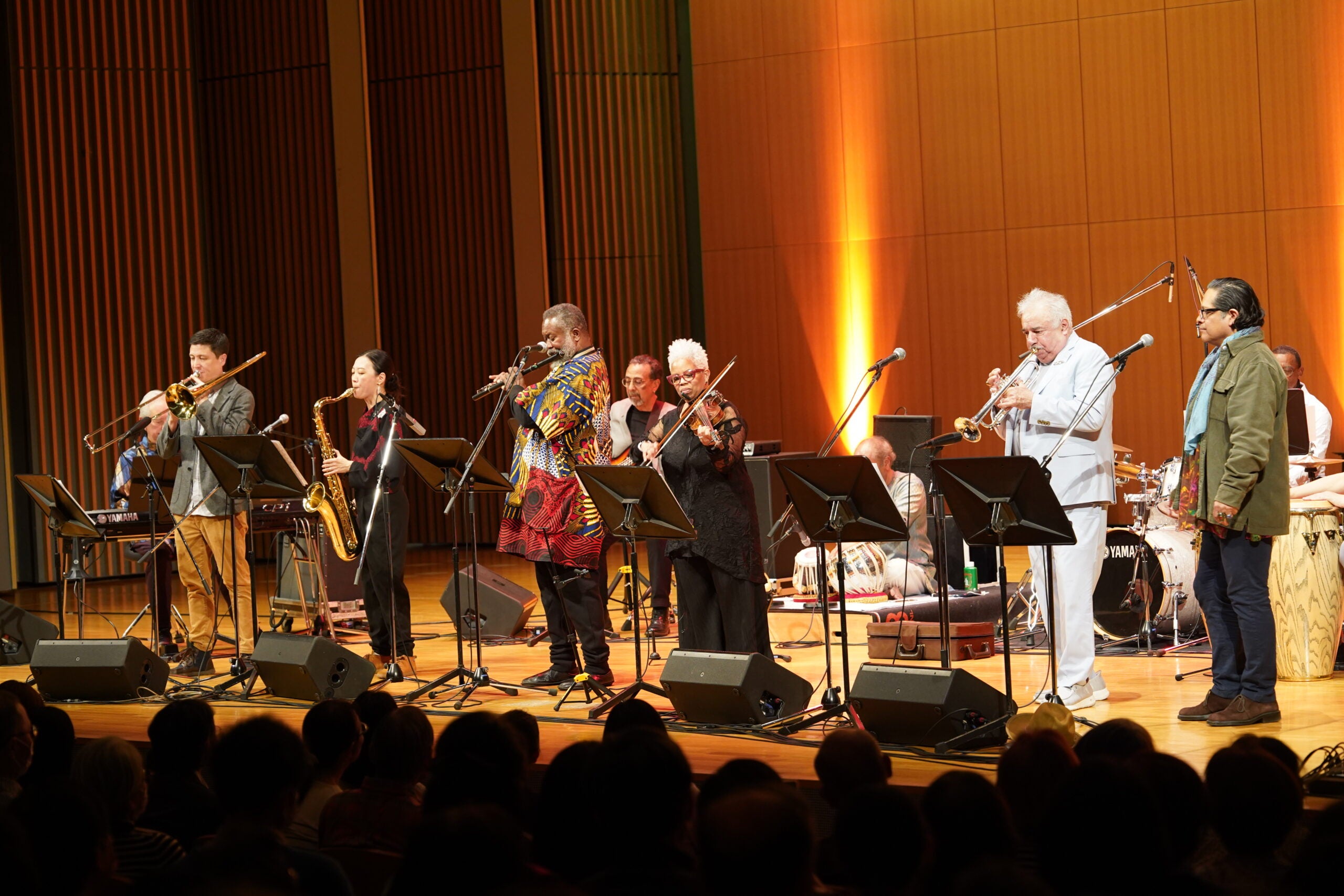 Jazz musicians on stage standing in a line.