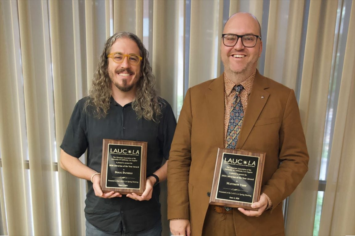 Librarians Doug Daniels and Matthew Vest Doug posing with their Librarian of the Year award plaques.
