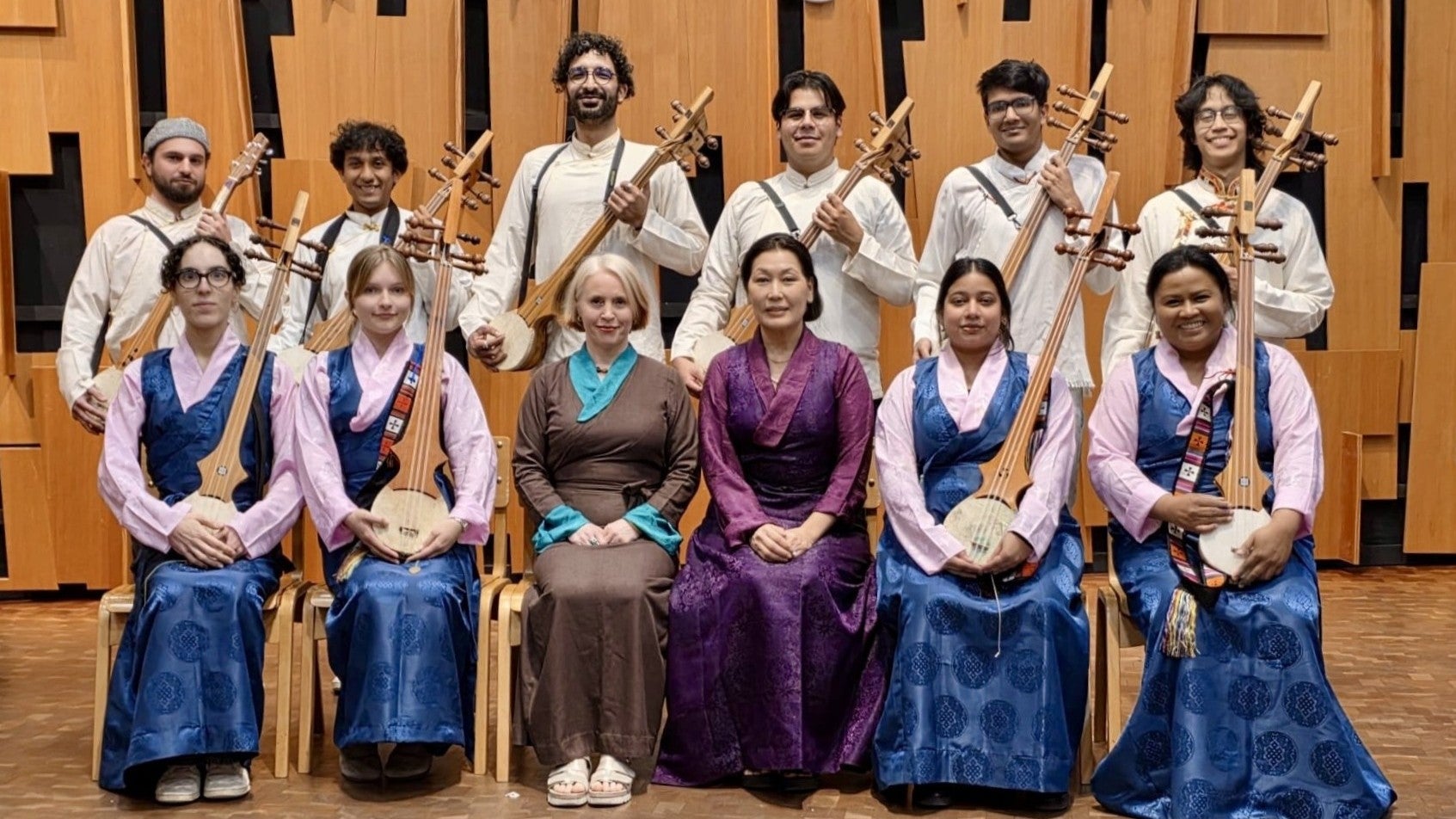 Music of Tibet ensemble poses for a picture with their instruments.
